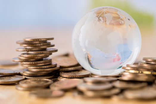 coins stack and glass globe.