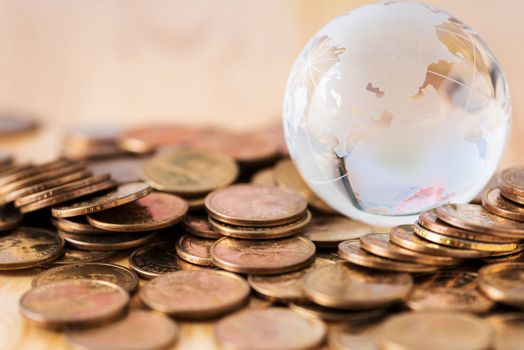 coins stack and glass globe