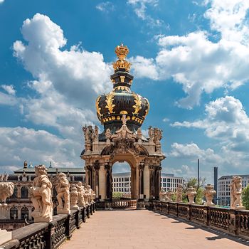 The crown gate of the famous baroque Zwinger, surrounded by sculptures in the old town of Dresden.
