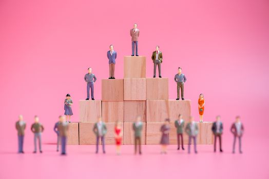 business miniature people on stack of wood cube building block.