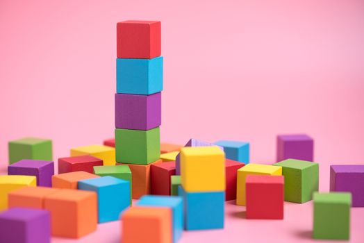 Colorful stack of wood cube building blocks.