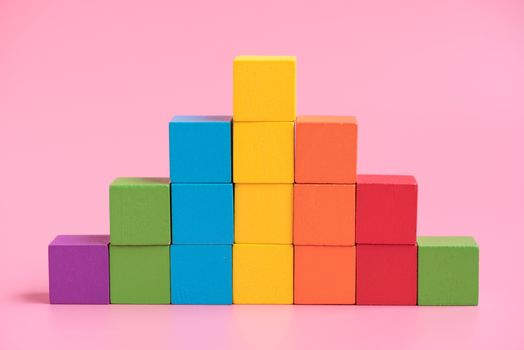 Colorful stack of wood cube building blocks.