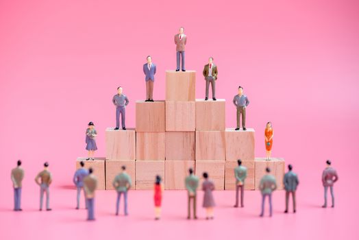 business miniature people on stack of wood cube building block.