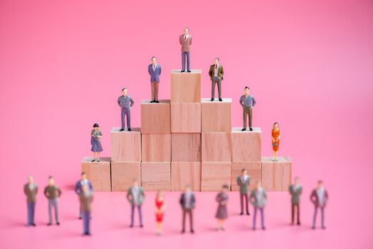 business miniature people on stack of wood cube building block.