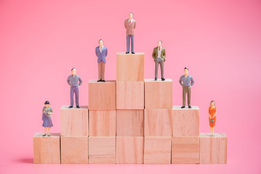 business miniature people on stack of wood cube building block.