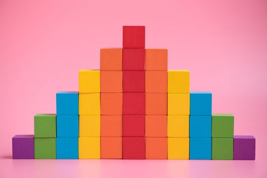 Colorful stack of wood cube building blocks.