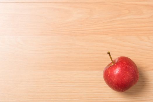 red apple on wood background.