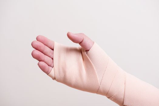 wounded hand cover with bandage.