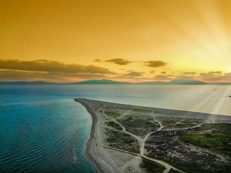 Evening aerial top view of Possidi Cape in Sithonia Chalkidiki peninsula, above an empty sandy beach.
