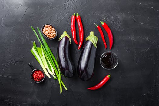 Sticky teriyaki aubergine ingredients, for cooking or grill chili pepper, eggplant, sauce, nuts on black background.