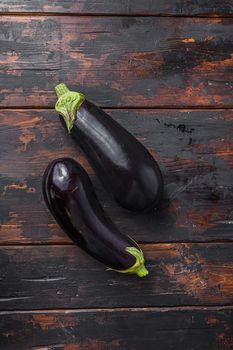 Fresh healthy raw Purple Eggplant on a kitchen old dark wooden table. Top view