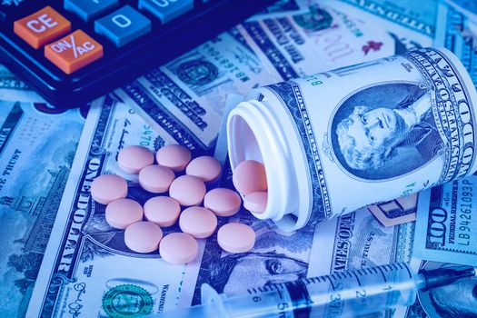 Medicine pills and black calculator with dollars. Pharmacy prescription for health. Concept of cost of the healthy life.