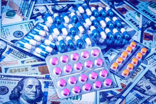 Plate with pills on the background of one hundred dollar bills. The concept of the expensive cost of healthcare or financing medicine.
