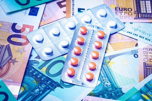 Plate with pills on the background of euro bills. The concept of the expensive cost of healthcare or financing medicine.