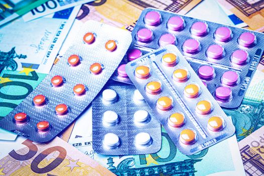 Plate with pills on the background of euro bills. The concept of the expensive cost of healthcare or financing medicine.