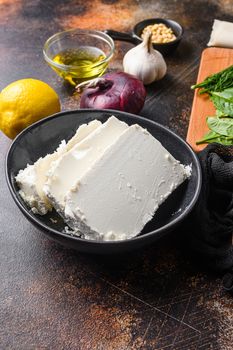 Traditional feta cheese in black bowl side view