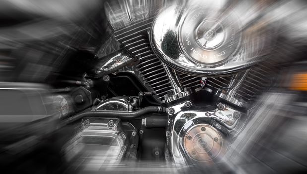 Jesolo (VE), ITALY - July 29, 2017: Motorcycle Harley Davidson. Motorcycle tank and engine's details. Radial blur action effect applied.