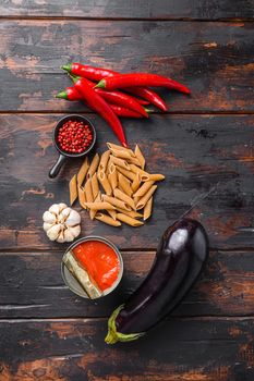 Aubergine penne ingredients eggplant pasta, pepper tomatoe sauce, on old wooden table top view