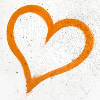 Concept or conceptual painted orange abstract heart shape love symbol, dirty wall background, metaphor to urban and romantic valentine, grungy style.