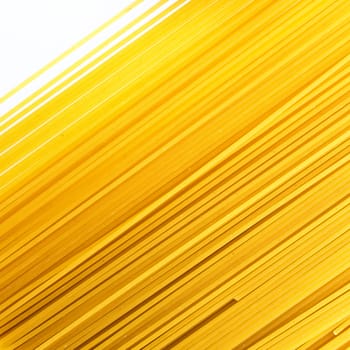 Uncooked spaghetti lie on a diagonal direction