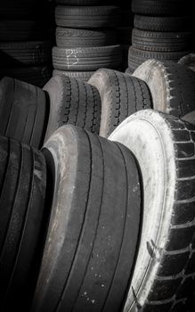Old tires, stacked artfully, framed vertically.