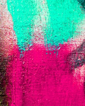 Fragment of colorful graffiti painted on a concrete wall. Bright abstract backdrop for design.