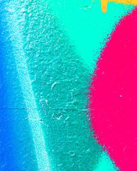 Fragment of colorful graffiti painted on a concrete wall. Bright abstract backdrop for design.