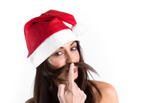 Smiling woman with hat of Santa Claus on her head, playing with her brown hair.