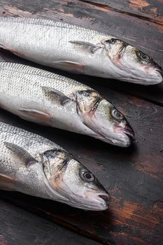 Whole sea bass on old fisherman wooden table side view