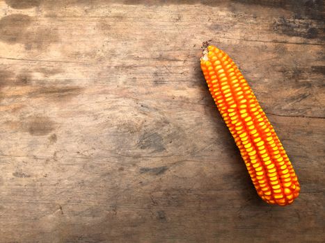 Dried corn used for cattle placed on a wooden floor.