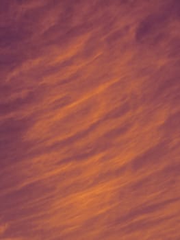 The abstract evening sky with the waves of clouds fluttering from the wind.