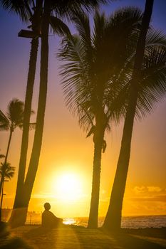 A silhouette watches the sunrise on Kauai, Hawaii.