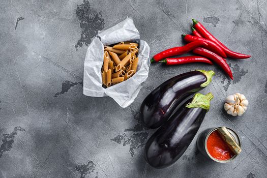 Aubergine penne arrabiata ingredients, top view space for text