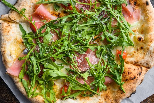 Italian pizza with mozzarella, cheese and basil leaves on old surface. Top view, close up