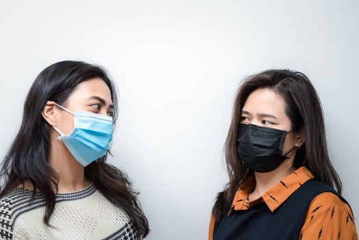 Asian pretty women wearing mask respiratory protection mask against epidemic flu covid19 or corona virus influenza in office with fear emotion in concept illness, outbreak, healthcare in life