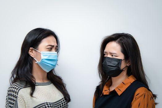 Asian pretty women wearing mask respiratory protection mask against epidemic flu covid19 or corona virus influenza in office with fear emotion in concept illness, outbreak, healthcare in life