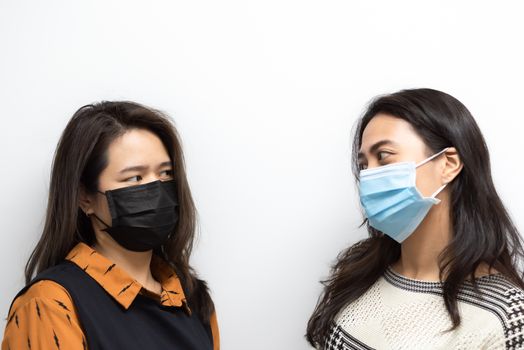 Asian pretty women wearing mask respiratory protection mask against epidemic flu covid19 or corona virus influenza in office with fear emotion in concept illness, outbreak, healthcare in life