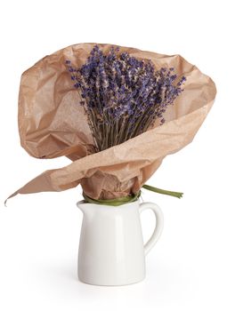 Dry lavender bouquet wrapped in craft papper in the jug