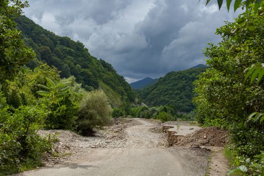 Dirt road in the stonebed of river Ashe at the summer day