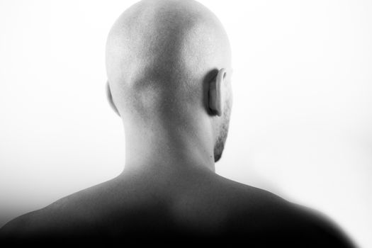 shaved head behind statue clean skin skinhead white background