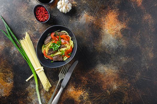 Wok with noodles and stir fry beef top view space for text