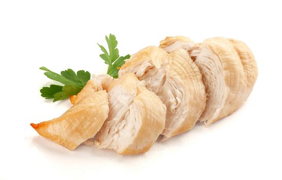 Isolated backed chicken fillet with green leaves of parsley