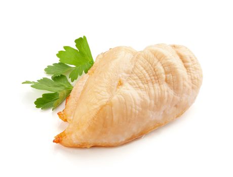 Isolated backed chicken fillet with green leaves of parsley