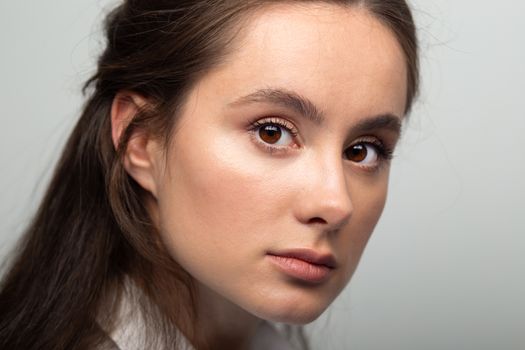 portrait of cute beautiful young woman close-up. woman facing camera with big eyes.