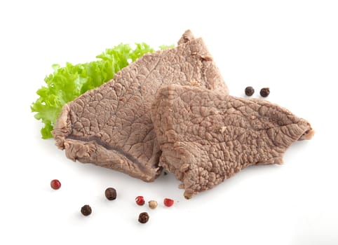 Isolated cooked beef and fresh green lettuce