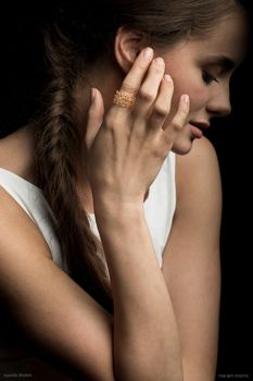 woman hand. woman hands and face. fashion accessories ring on finger woman fashion portrait on black background.