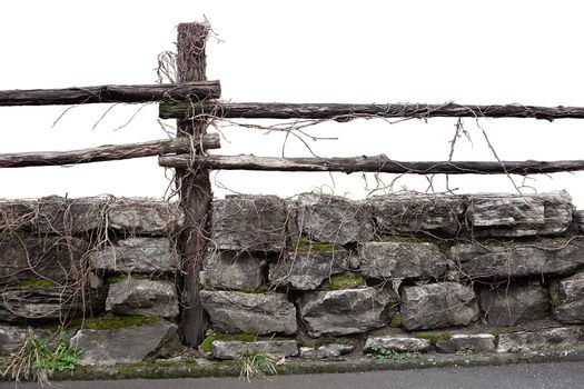 Fragment of stone and wooden fence at the spring