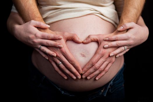 pregnant couple in love with baby belly. Hands on stomach baby bump. husband hand pregnant belly