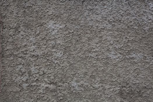 Fragment of gray cement coated wall