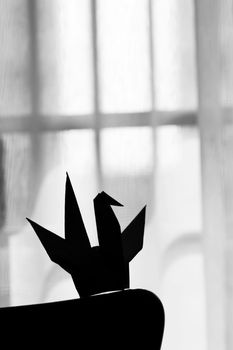 Silhouette origami paper crane in the living room